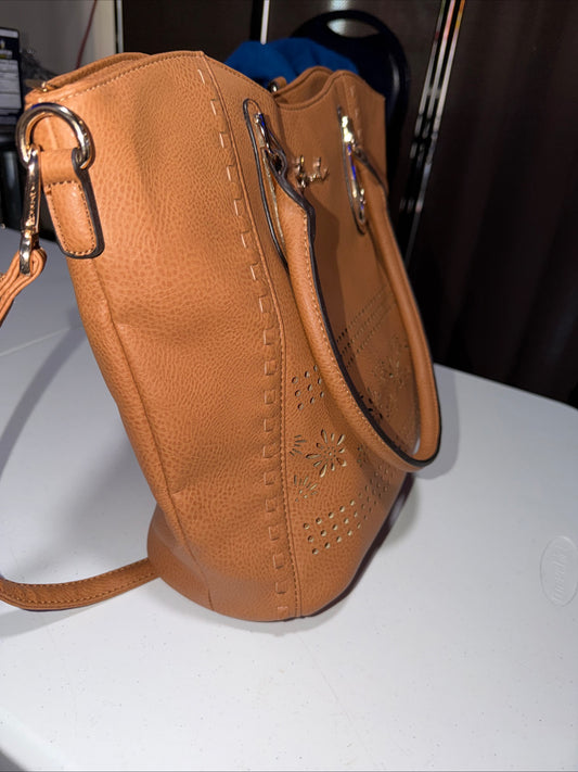 LerssaCi Tan Handbag With perforated floral cutouts and gold-toned hardware.