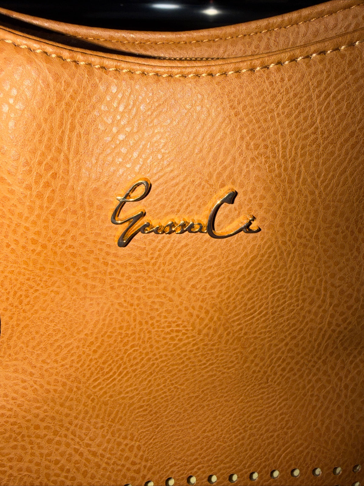 LerssaCi Tan Handbag With perforated floral cutouts and gold-toned hardware.