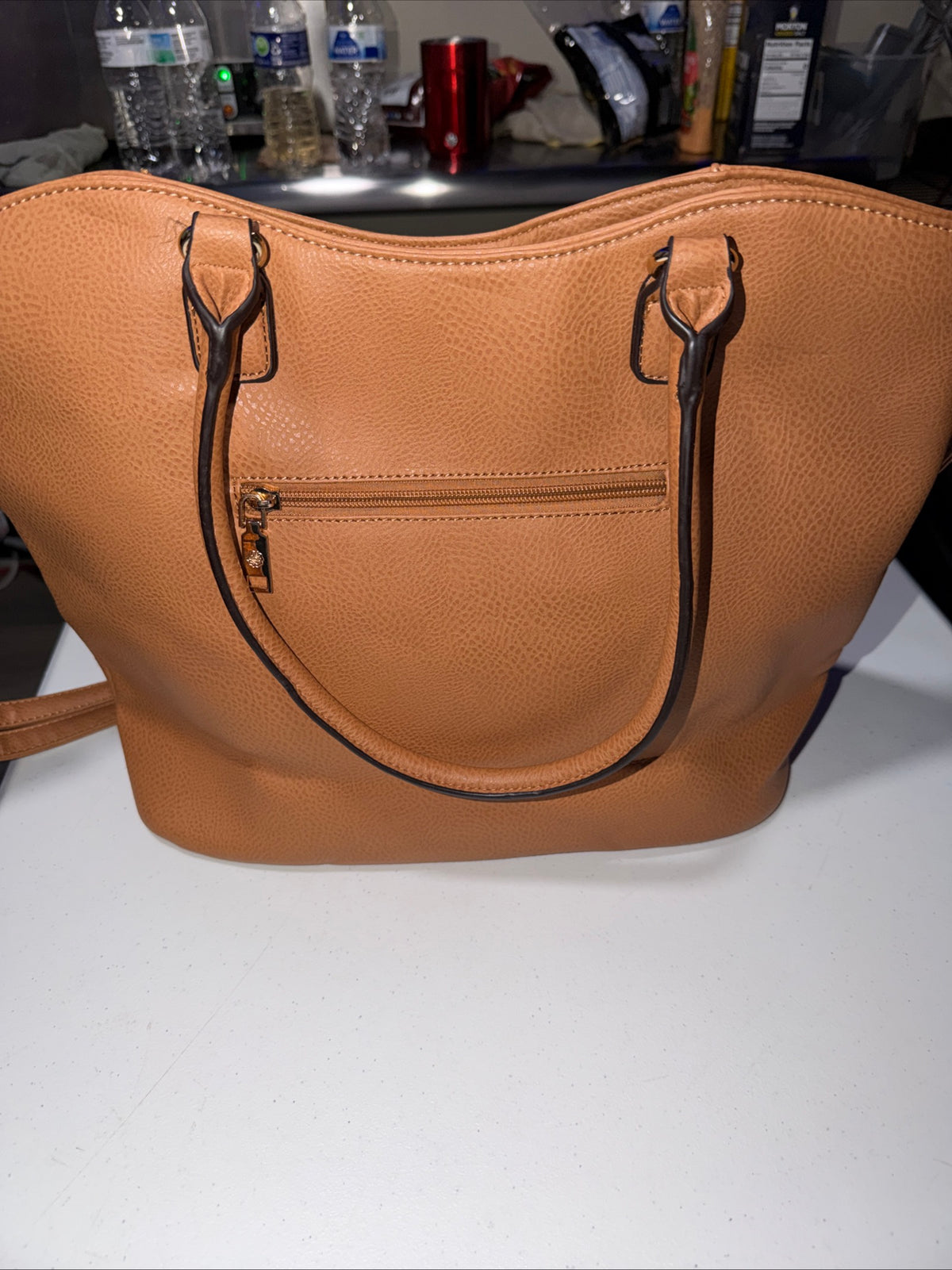LerssaCi Tan Handbag With perforated floral cutouts and gold-toned hardware.