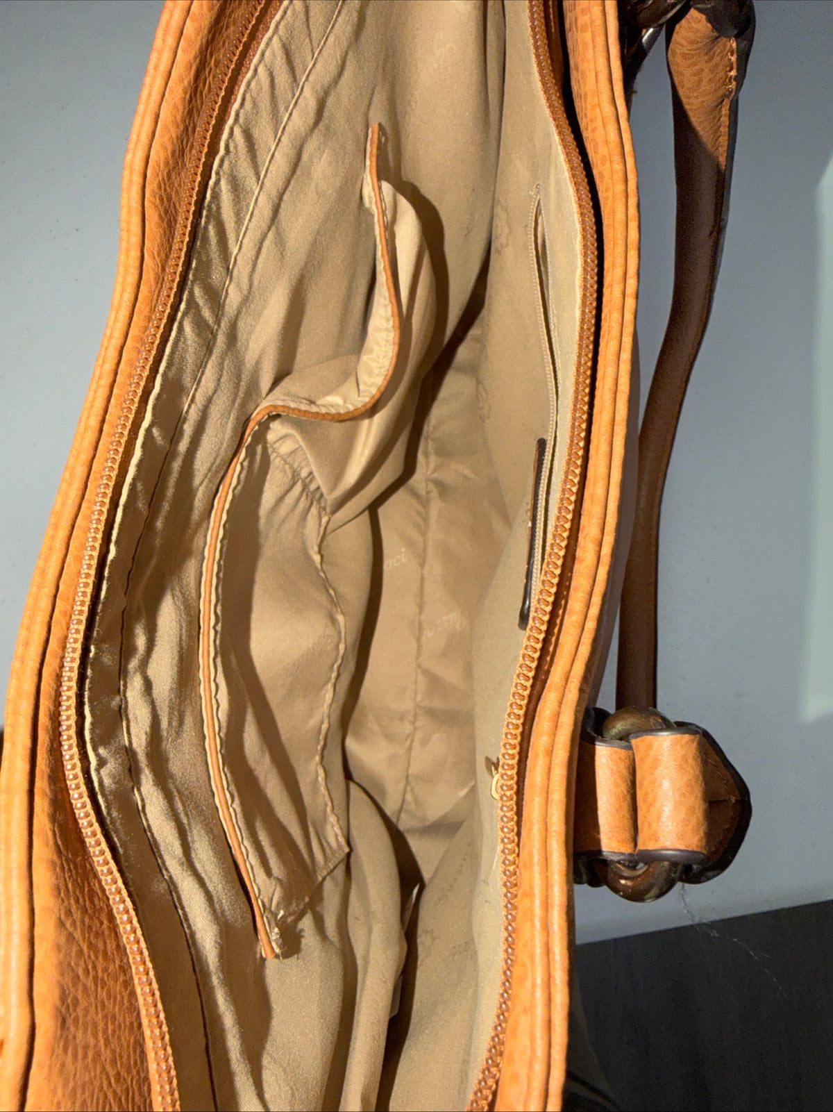 LerssaCi Tan Handbag With perforated floral cutouts and gold-toned hardware.
